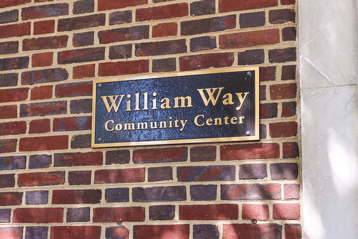 A sign for the William Way Community Center mounted to a brick wall
